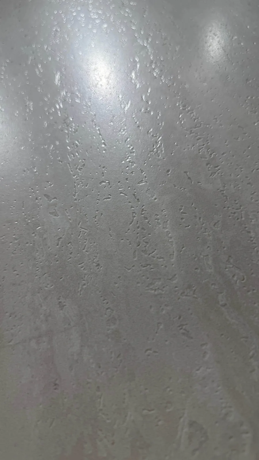 Surface detail for ivory linear sintered stone slab