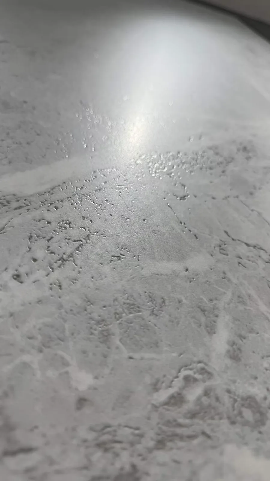 Surface detail for layered grey sintered stone slab