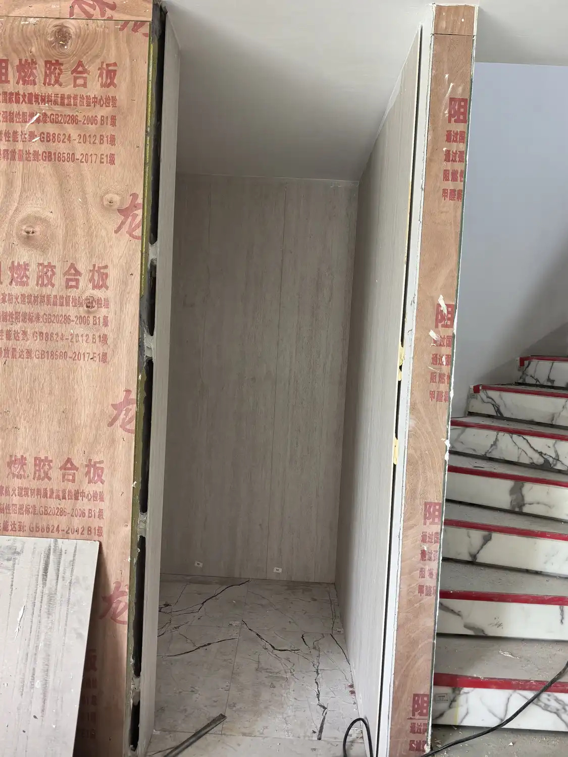 Vein-cut beige travertine wall cladding in elevator alcove