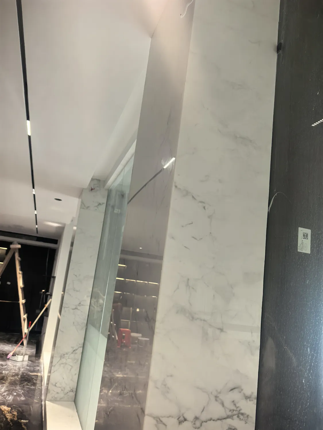 Book-matched Calacatta marble architectural column in lobby
