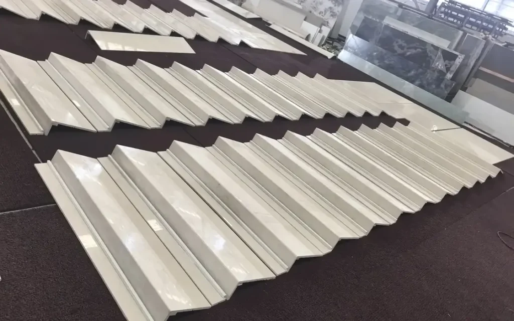 Stone profiles and cut components arranged on a factory floor
